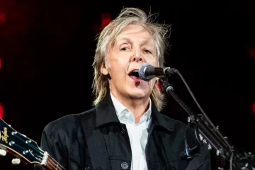 Paul McCartney cantando no palco durante show nos EUA, segurando seu icônico baixo Höfner — foto de MJ Kim.