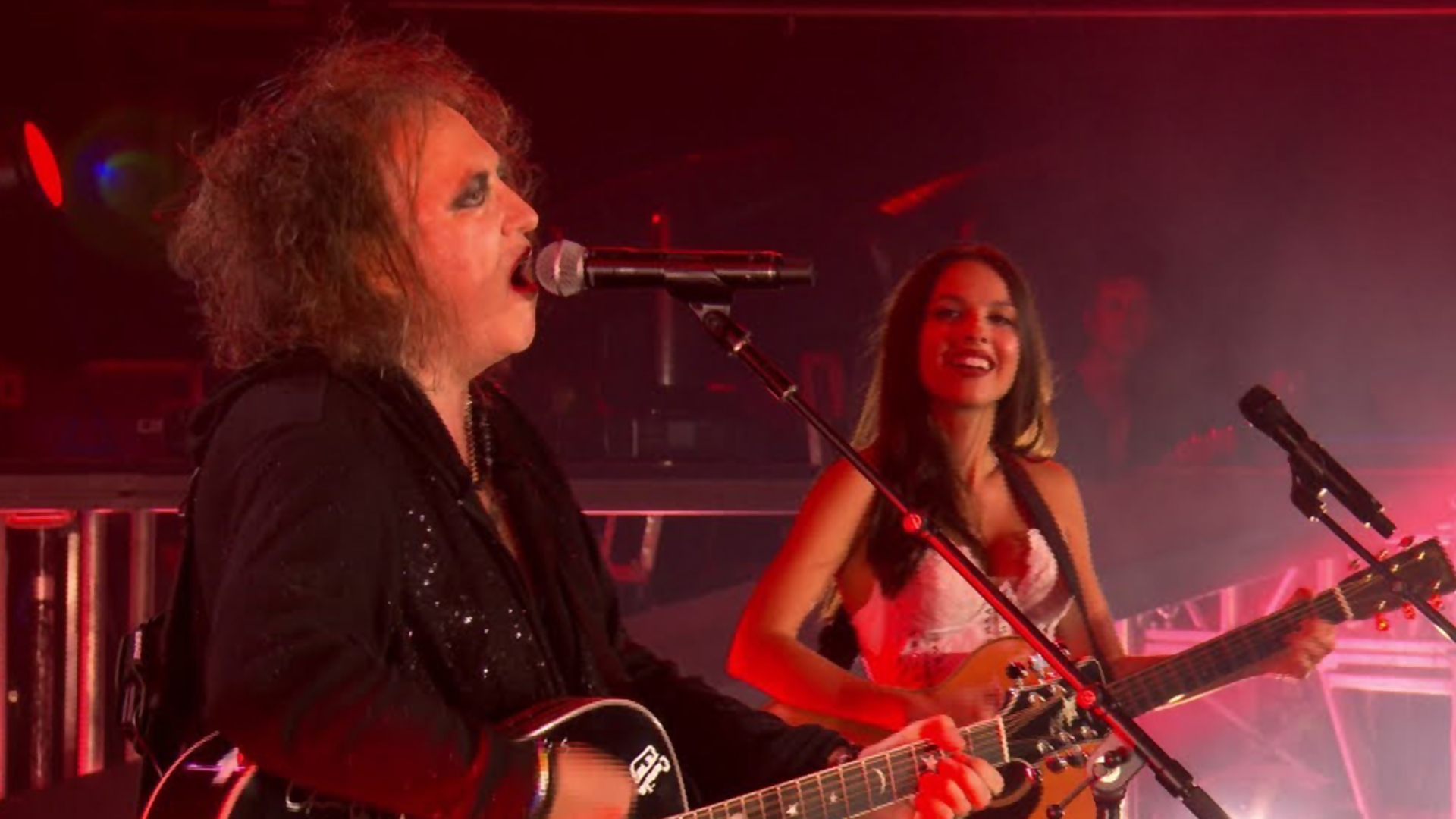 Olivia Rodrigo e Robert Smith, do The Cure, cantando juntos no Festival de Glastonbury 2024.