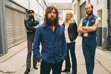 Banda Kadavar posa para foto promocional em um corredor urbano