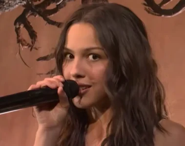 Olivia Rodrigo cantando ao vivo no SNL com microfone em close
