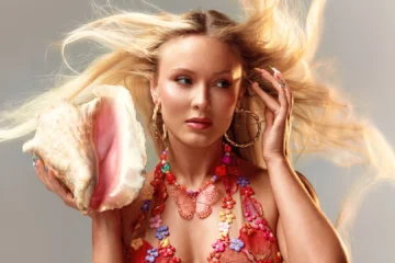 Zara Larsson segura uma concha em ensaio inspirado na estética de Midnight Sun